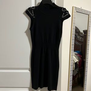 Black high neck sweater dress with gems on the shoulder and open back